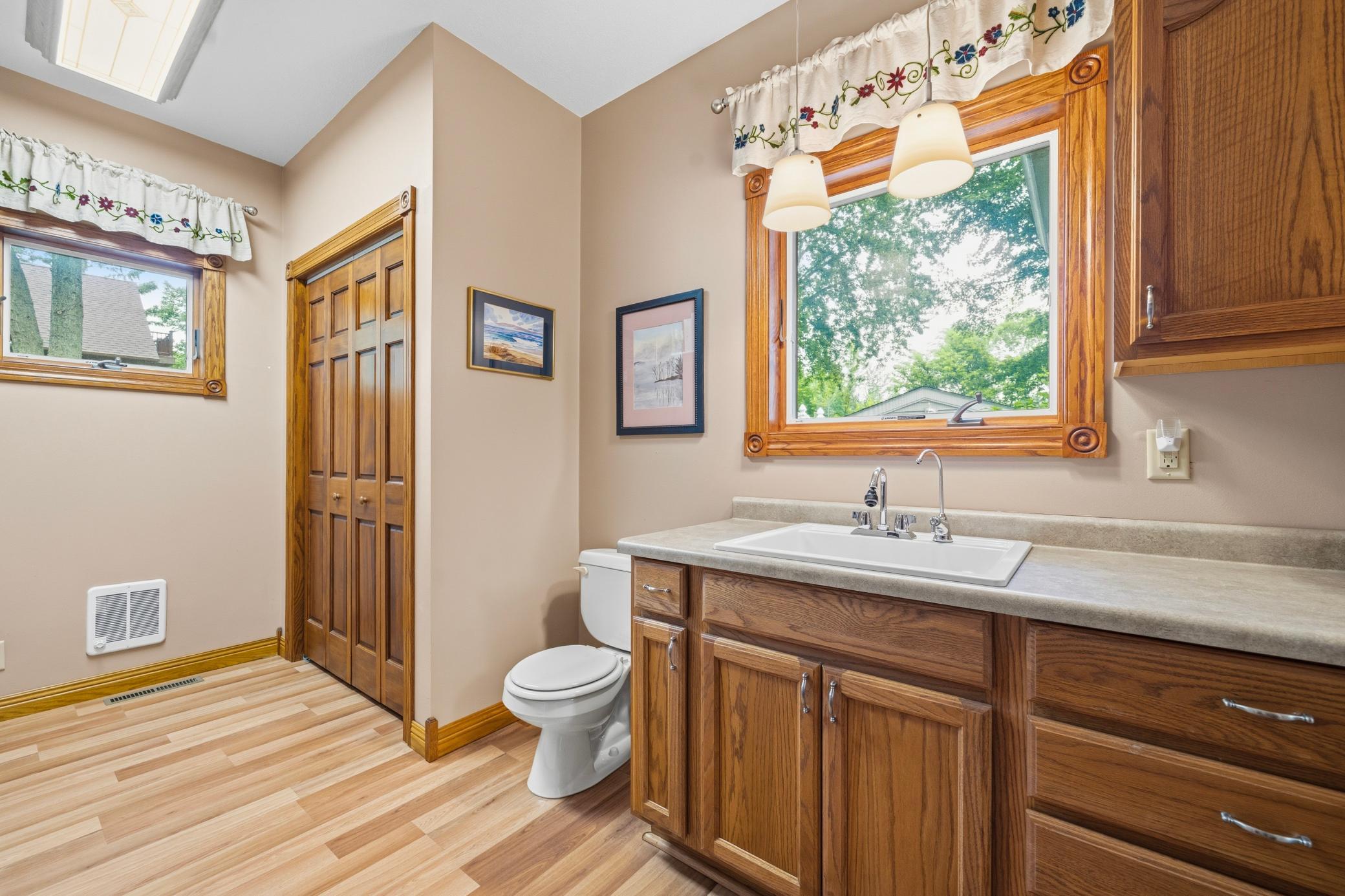 Laundry room and bathroom with storage.