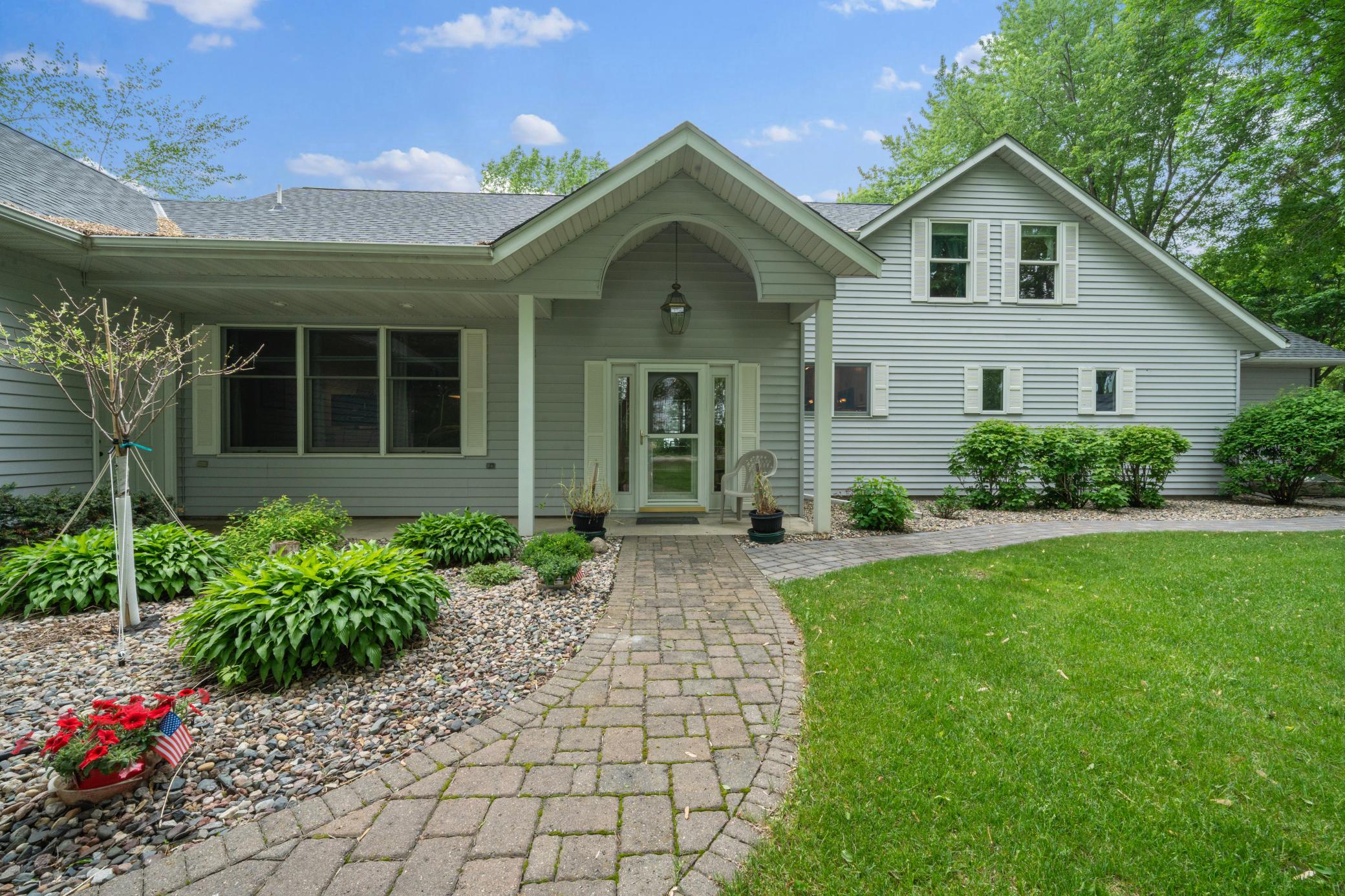 Paver entryway leads you to this luxurious home.