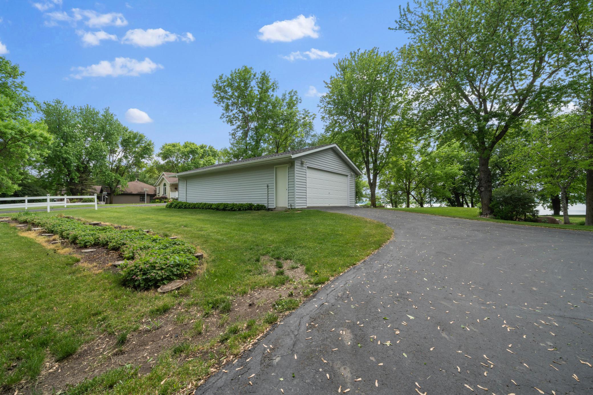 An additional detached garage ensures ample room for all your vehicles, lake toys, workshop needs, and seasonal storage.