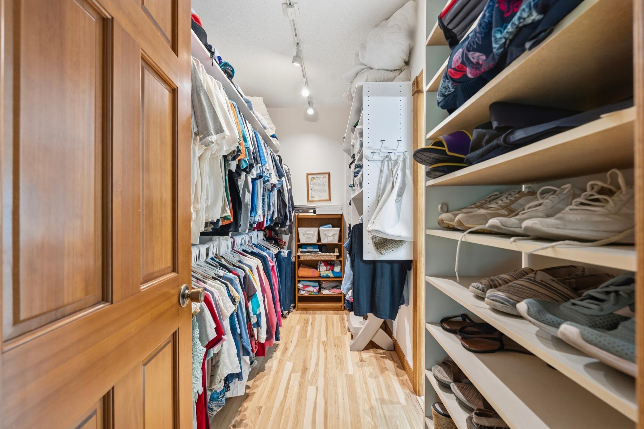 A walk-in closet emphasizes tidiness with storage solutions for all your clothes and accessories.