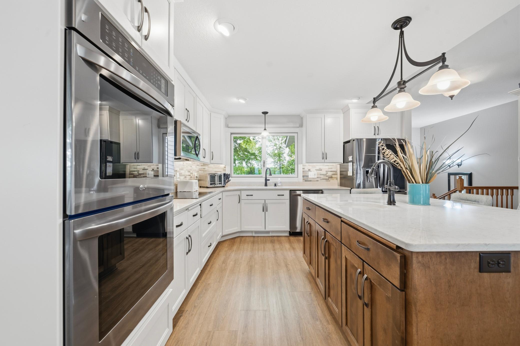 A closer look at the kitchen featuring stainless steel appliances and a convenient double wall oven.