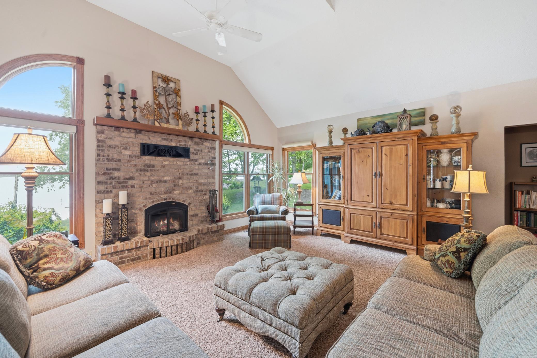 The living room is centered around a fireplace creating a cozy ambiance.