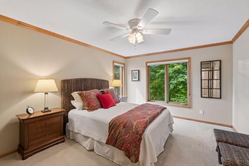 Completing the upper level's three-bedroom layout, this inviting room features a walk-in closet and built-in desk, creating a space that's as practical as it is welcoming.