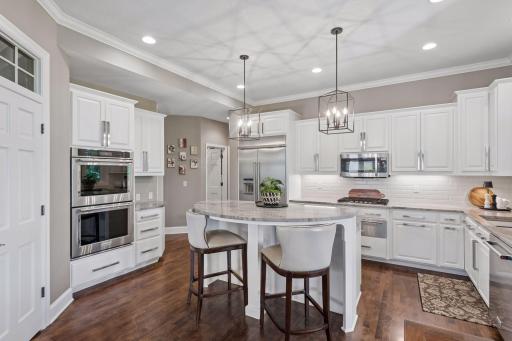 Thoughtfully updated with premium appliances, including double ovens, a five-burner gas cooktop, a warming drawer, and a French door refrigerator, this kitchen is ready for everything from weeknight meals to holiday gatherings.