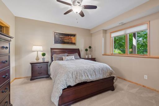 Tucked away from the upper-level bedrooms, this spacious suite enjoys direct access to a walk-through bath, creating a comfortable and private retreat for overnight guests or extended stays.