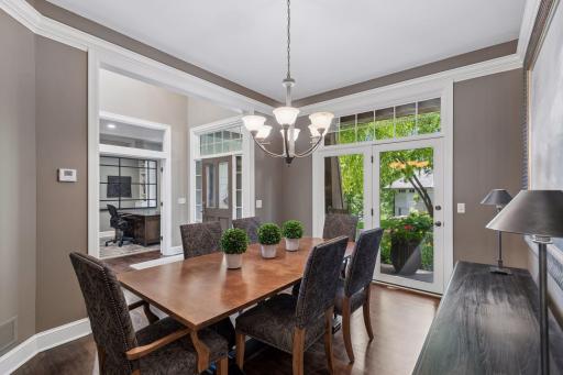 Just steps from the kitchen, the dining room also opens to the covered front porch, an inviting spot to slip outside with coffee in the morning or a glass of wine as the gardens bloom around you.