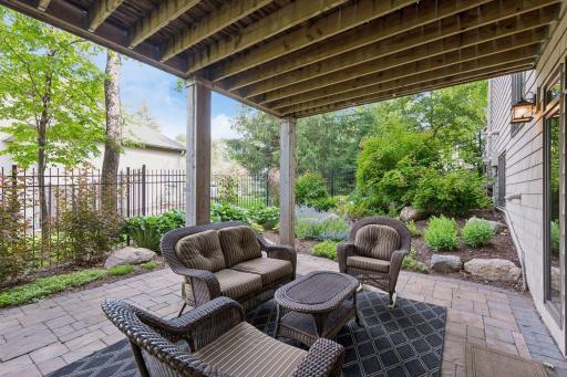Surrounded by mature landscaping and tucked beneath the cedar deck, this private patio feels like an outdoor room, perfect for relaxing, entertaining, or escaping the afternoon sun.