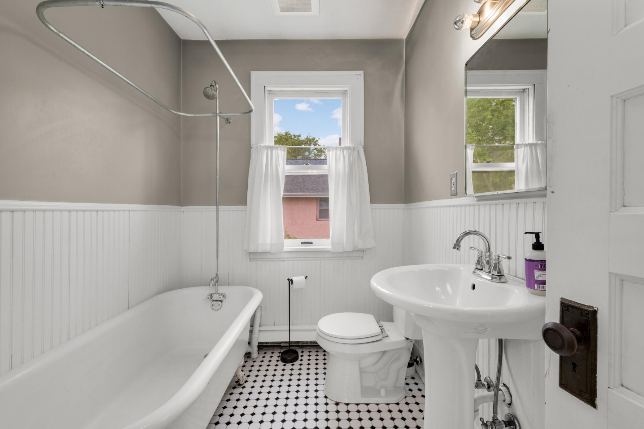 Bright, stylish bathroom with clawfoot tub/shower