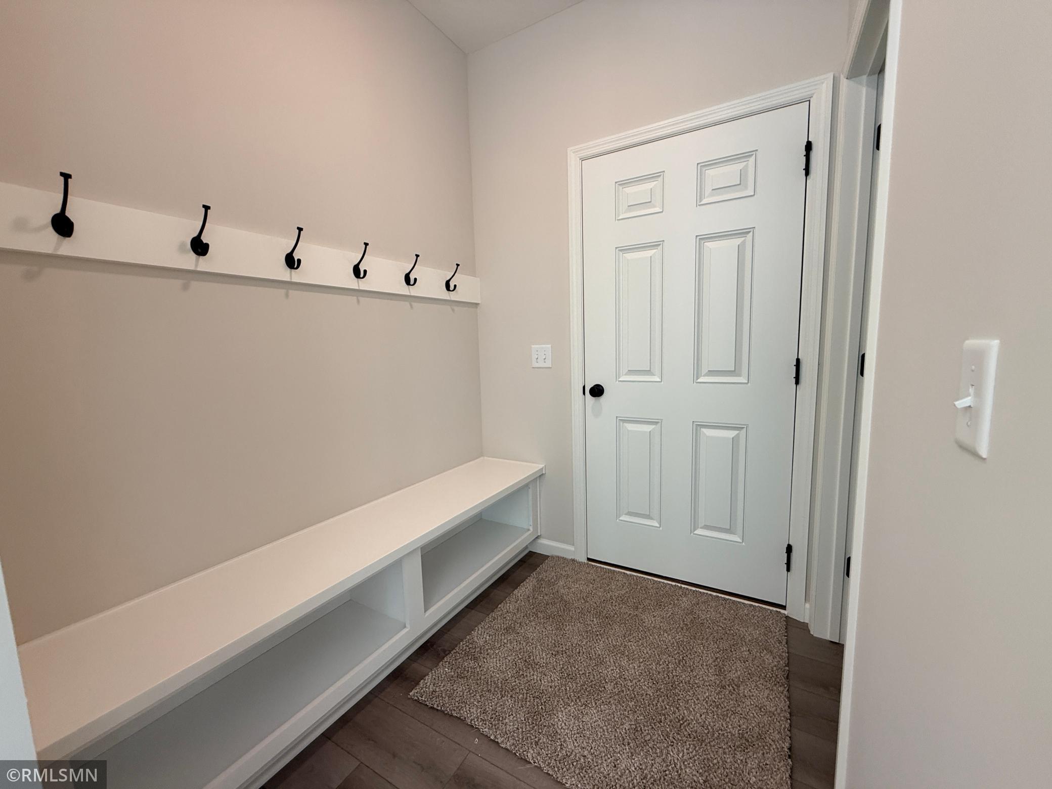 The garage entry/mudroom space includes a built in bench system for storing all your "out the door" needs.