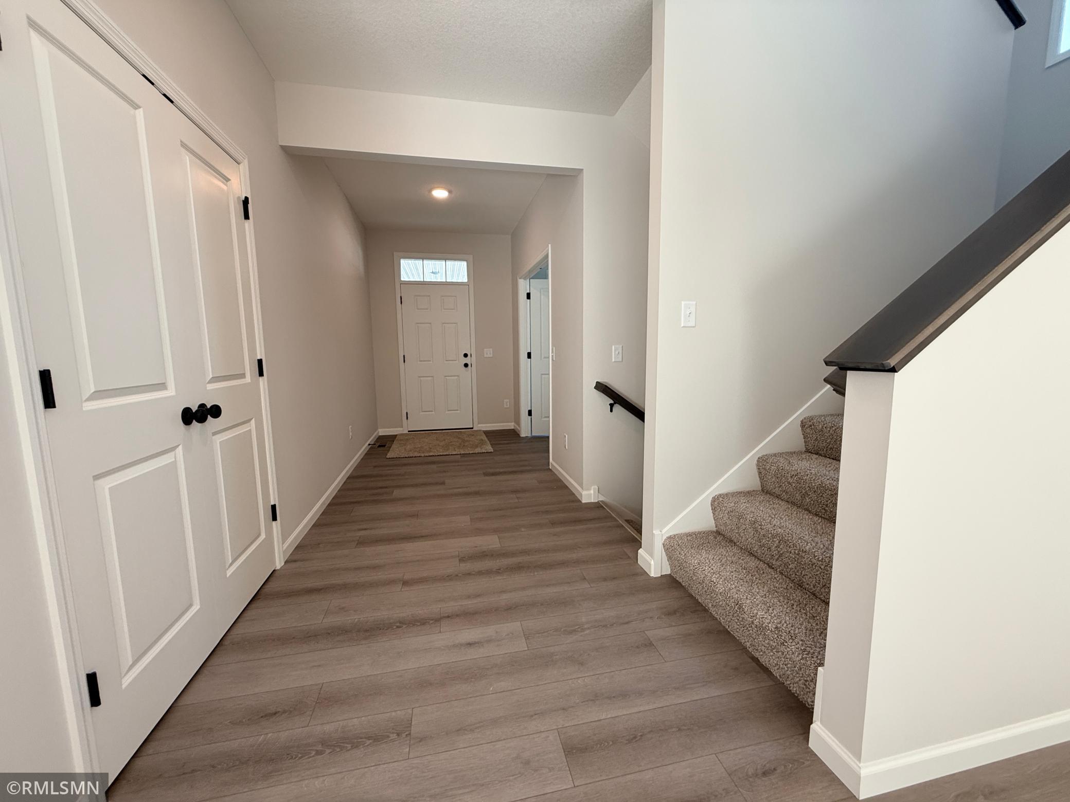 View of the huge foyer area - double door closet on the left of photo; both staircases and flex room on the right of the photo.