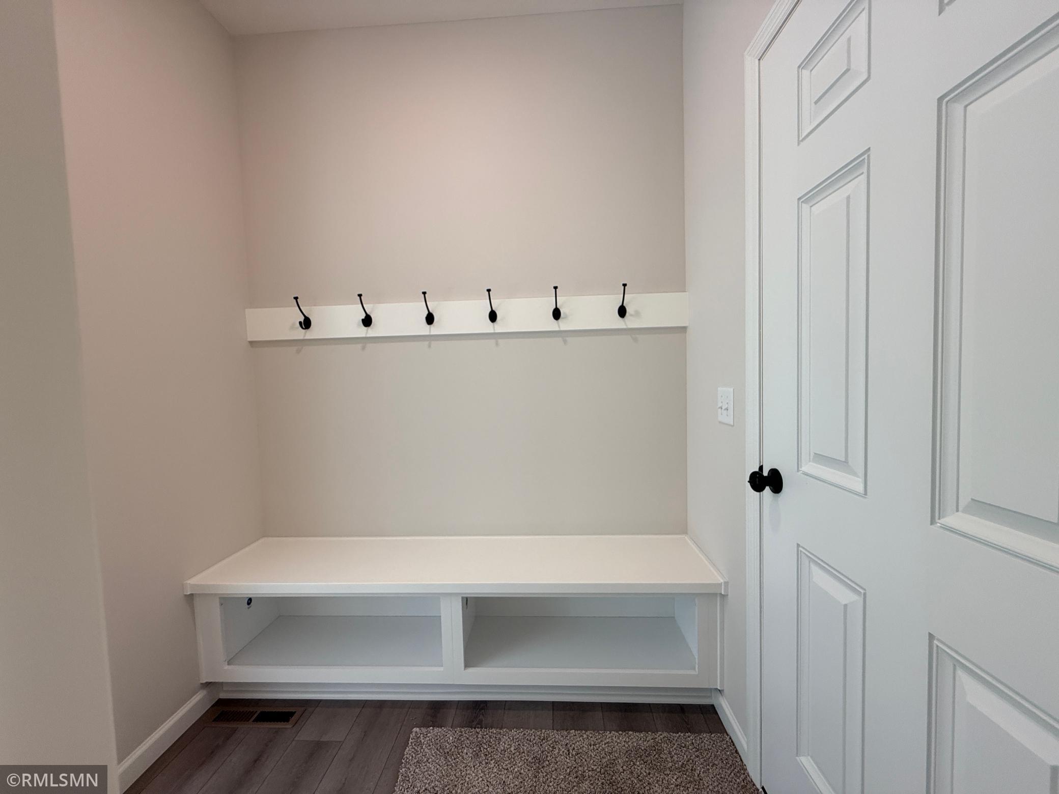The garage entry/mudroom space includes a built in bench system for storing all your "out the door" needs.