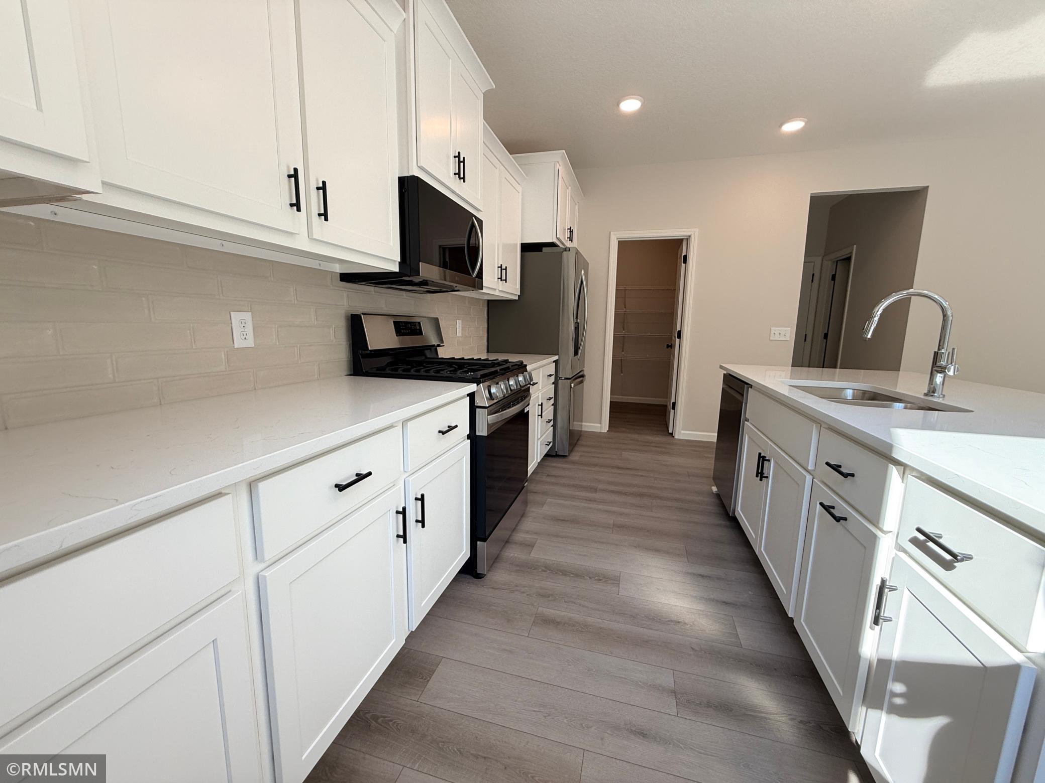 Loads of cabinetry and a huge island make this kitchen the heart of your home.