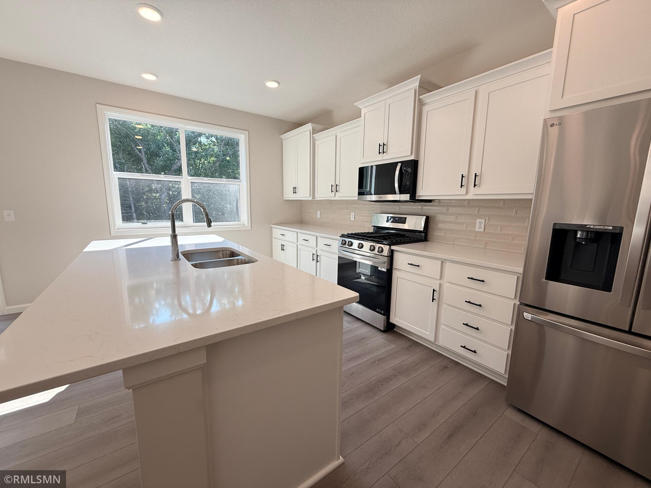 Loads of cabinetry and a huge island make this kitchen the heart of your home.