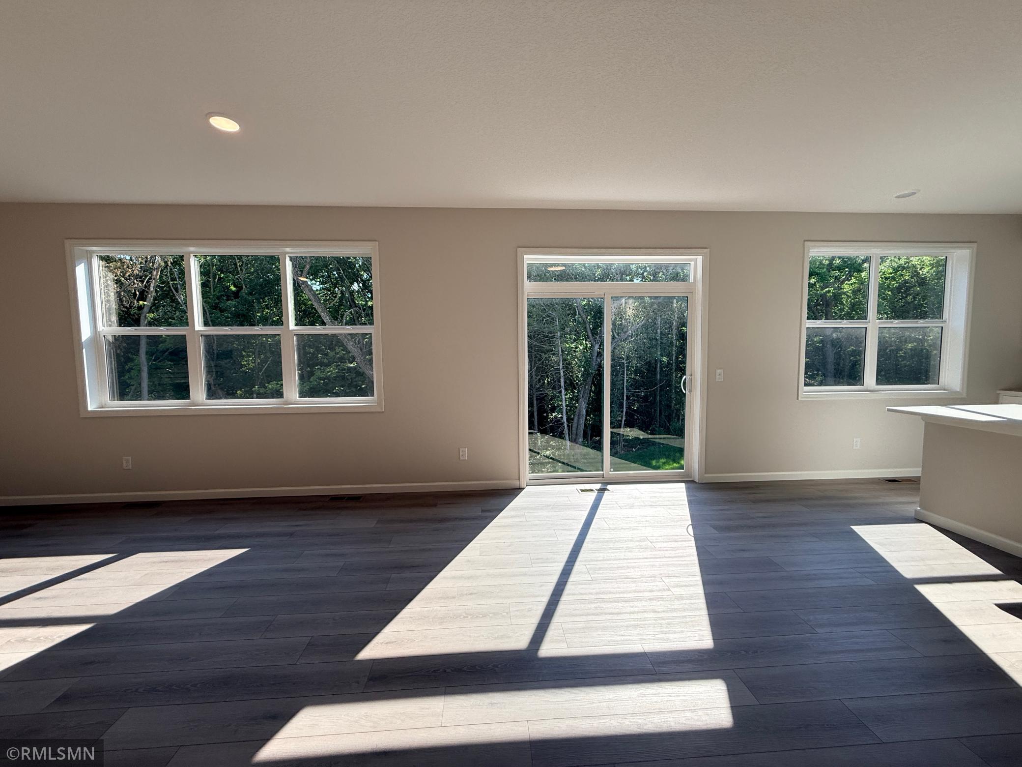 Enjoy the lush backyard views from your oversized banks of windows.