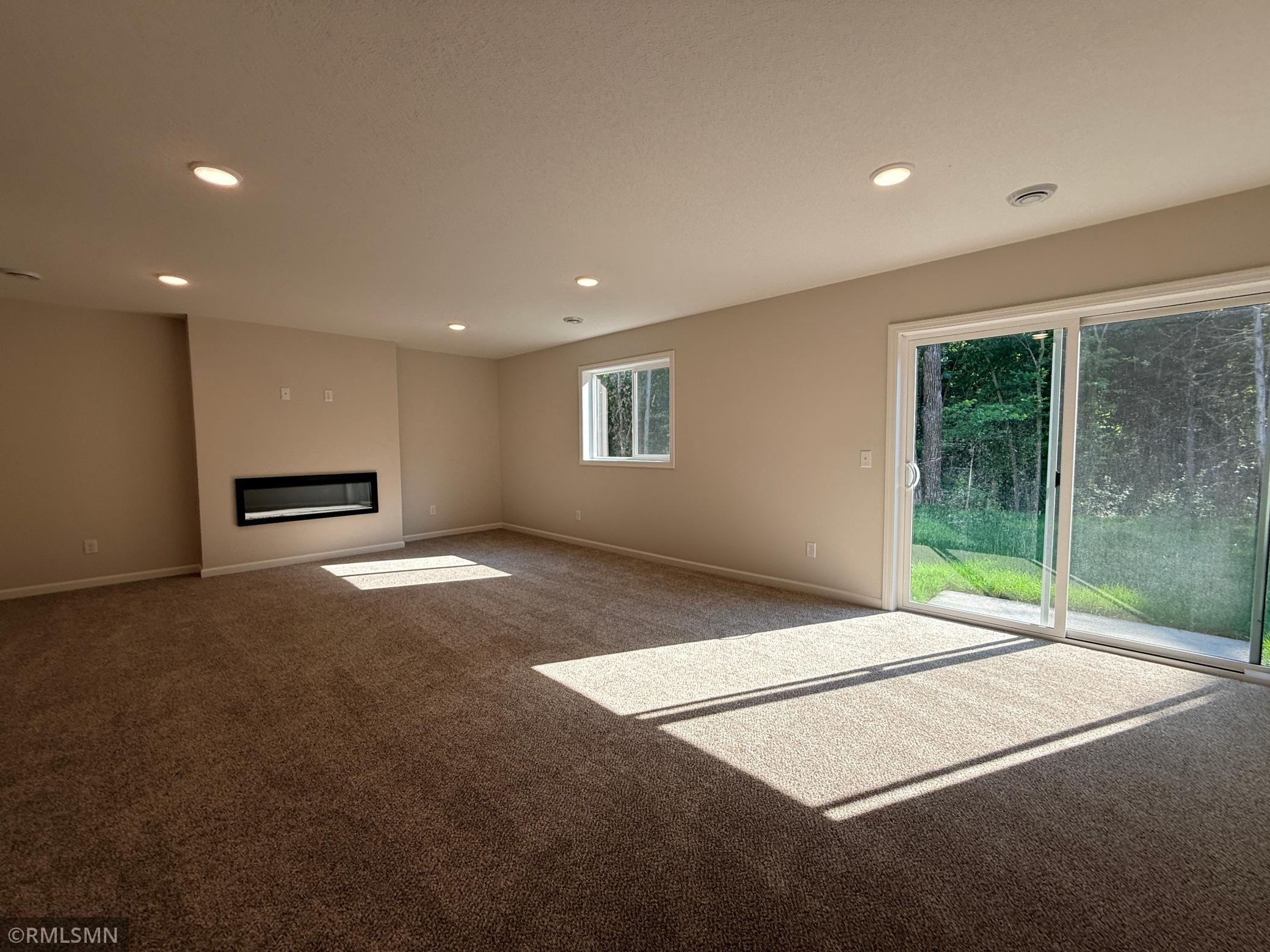 Huge lower level family room walks out to the lush backyard.