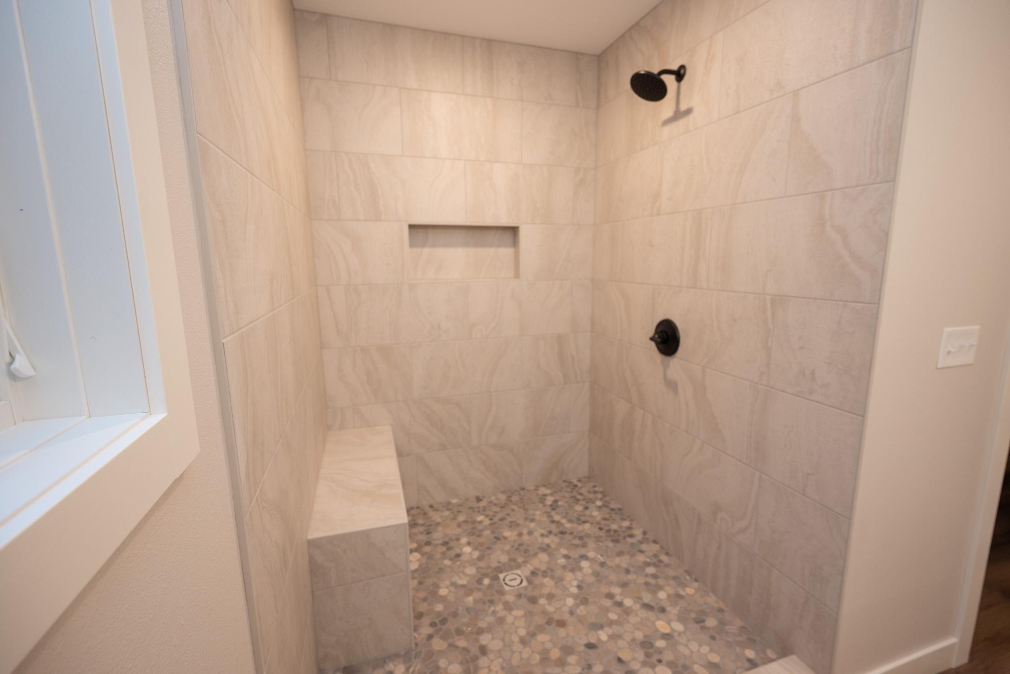Custom tiled walk-in shower in the primary bath!