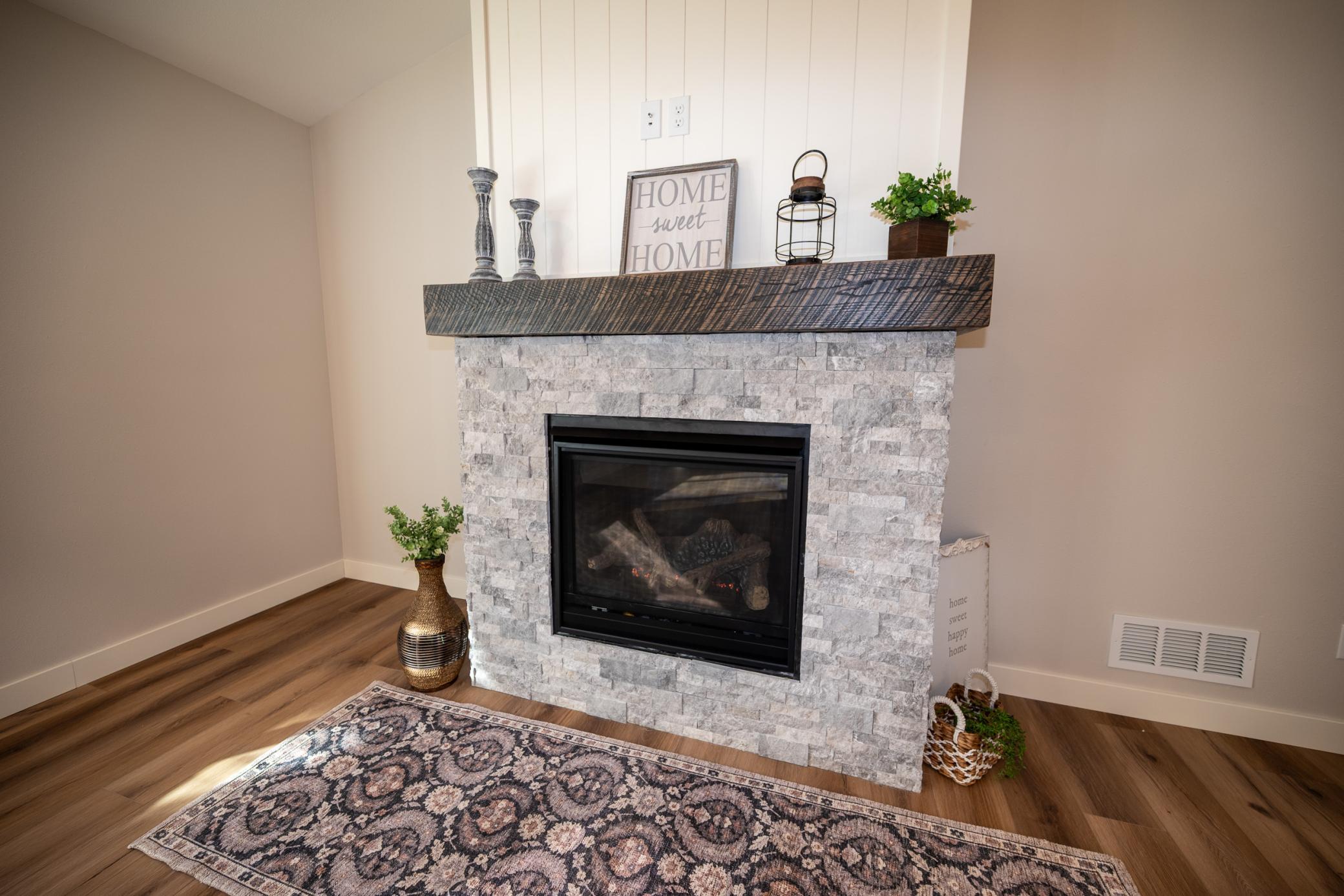 Relax by the warmth of the fire! Look at the beautiful stone and custom built mantel!