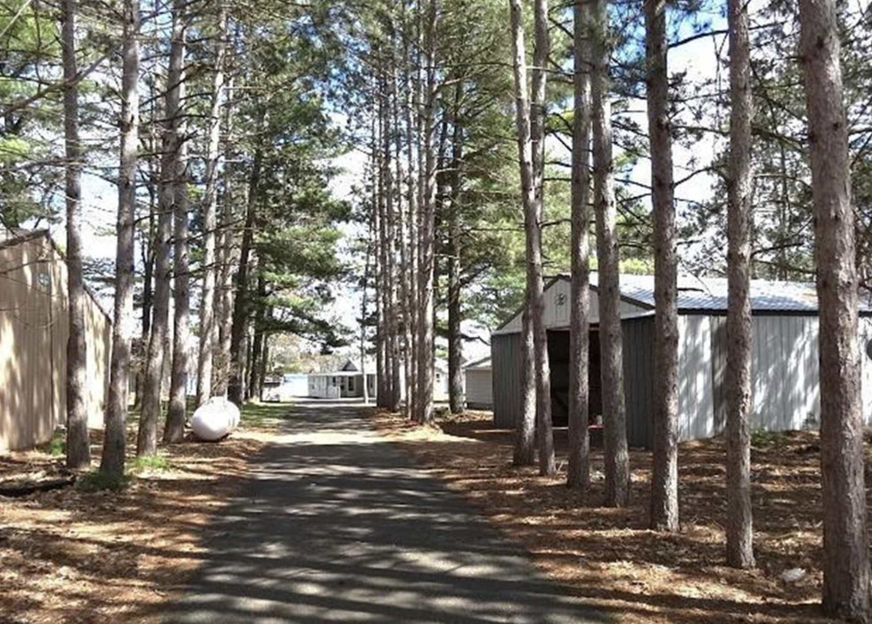 Driveway with polebarn and garage on the right.