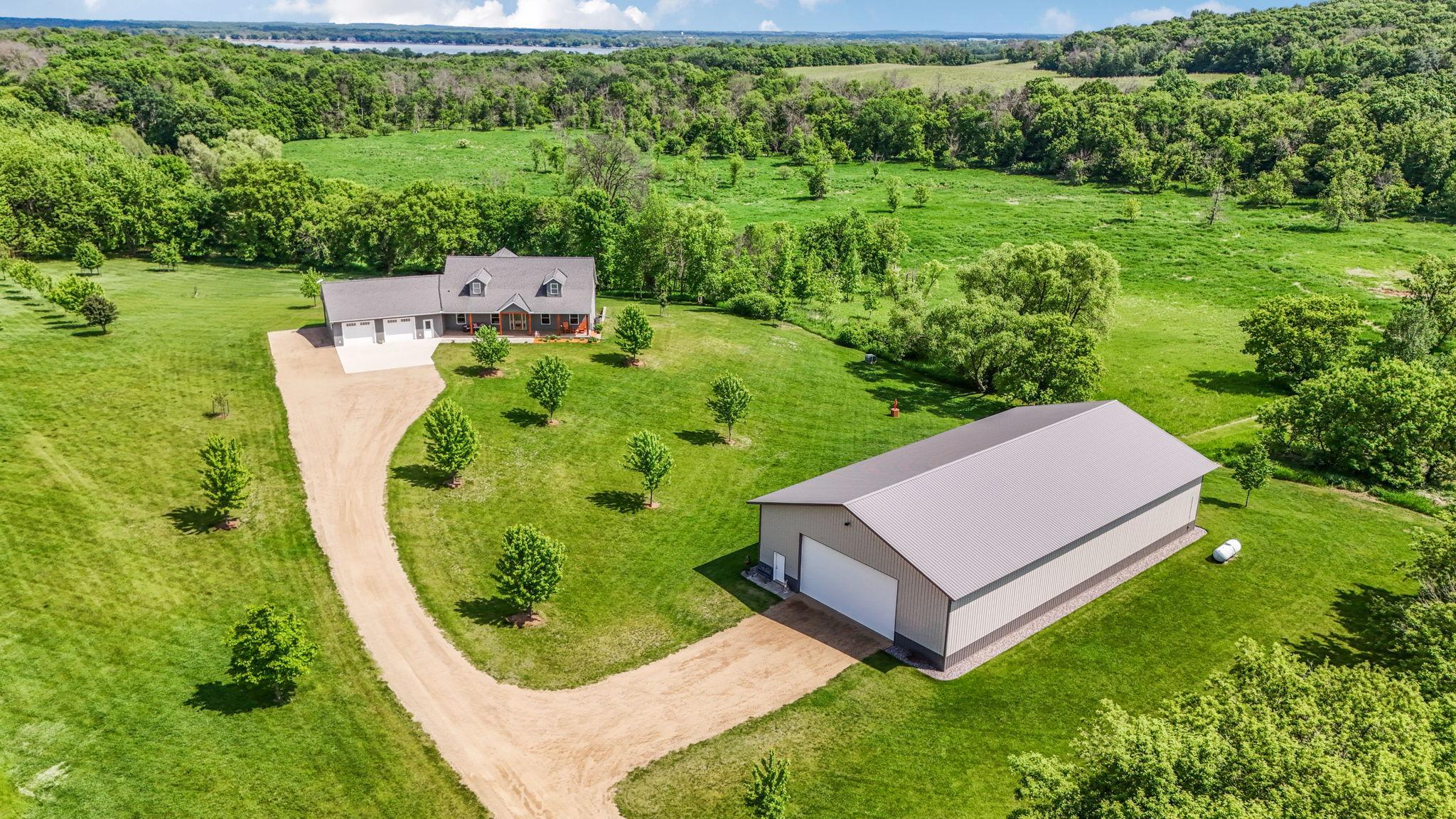 Upon entering the property you are greeted by the 100x50 outbuilding. The back 32x50 is a fully insulated and heated shop with electrical, water and floor drain