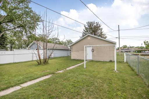 The detached two-stall garage features cement board siding for added durability, and there is even a clothes line for drying laundry outdoors if desired.