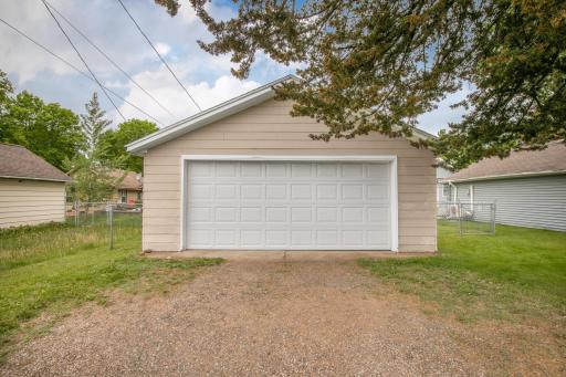 Large garage with extra parking space outside.