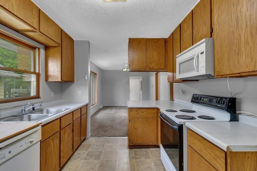 The efficient galley-style kitchen is thoughtfully designed with abundant cabinetry and generous countertop space.