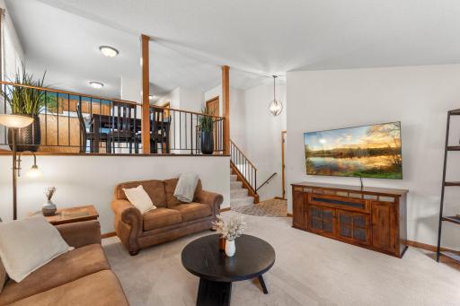 The main-level living room feels bright and airy with high ceilings.