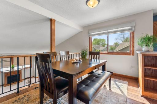 Overlooking the living space, the adjoining dining area showcases timeless hardwood flooring (2024).