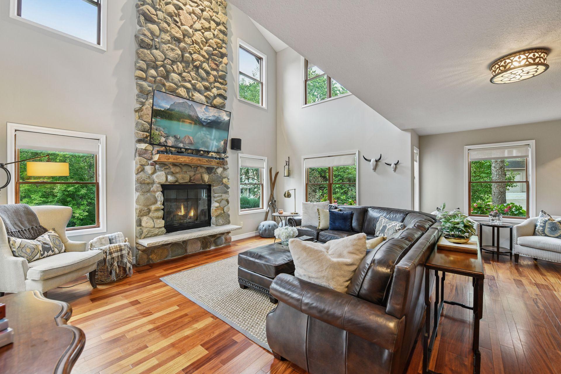 The front door opens to reveal a spacious open floor plan anchored by rich rosewood floors.