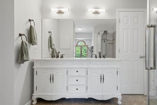 Bathroom features double sinks & massive mirror.