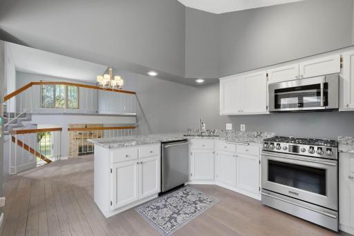 Main level kitchen features hardwood floors & stainless steel appliances!