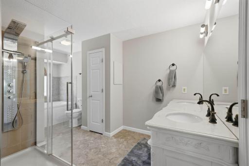 Primary bedroom walk thru bathroom is fresh & clean.