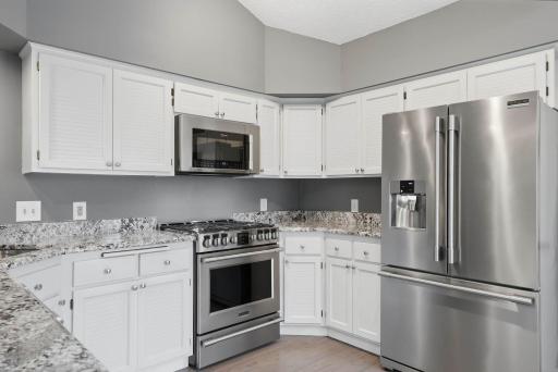 Kitchen features granite countertops & ample storage.