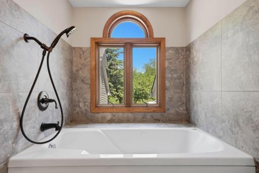 Bathroom features jetted soaker tub w/ beautiful natural light beaming in.