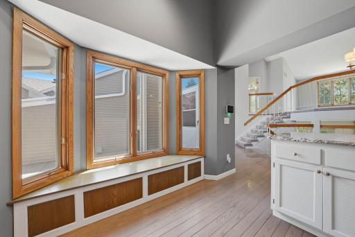Sizable bay window brings in extra natural light to the kitchen & provides seating area to put shoes on before heading into the garage.