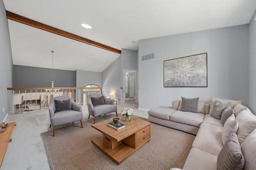 Beautiful faux beam accents the vaulted ceiling. Let's head to the primary bedroom! (virtually staged)