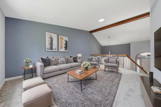 Living room features vaulted ceilings & skylight that pours in the natural light. (virtually staged)