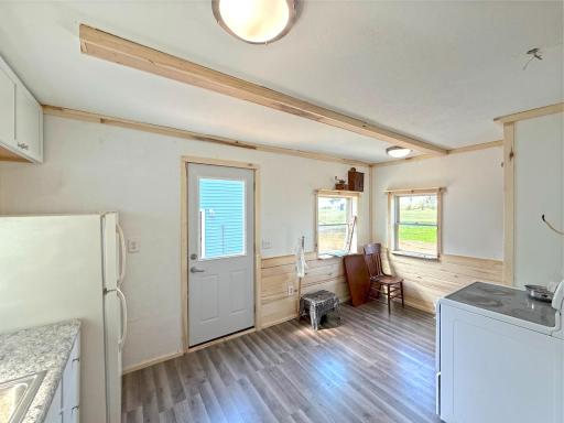 White cabinetry, updated countertops, many windows and durable flooring create a bright and functional workspace.