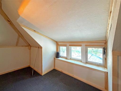 Featuring charming angled ceilings, window ledge and natural light from multiple windows, this space is ideal for a cozy retreat.