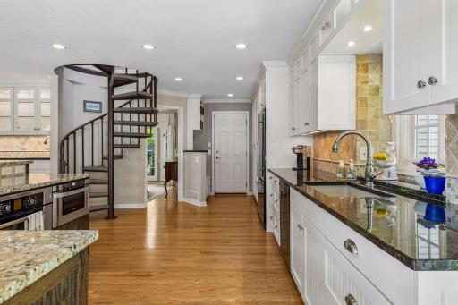 The charming spiral staircase adds architectural character while providing access between levels.