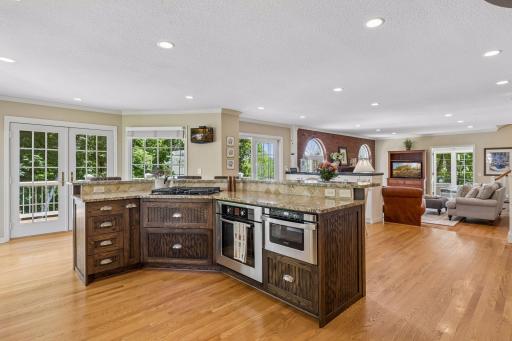 Kitchen highlights include kitchen center island with seating, stainless steel appliances, and natural light