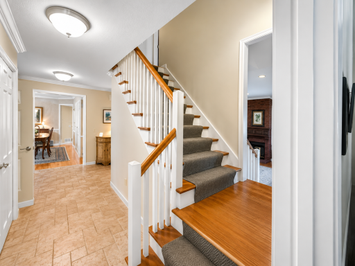 Grand staircase off of the foyer leads to the upper level.