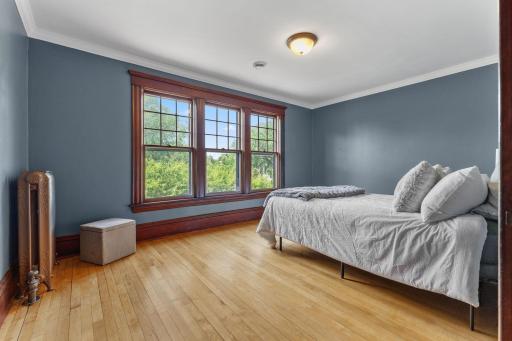 Large bedroom with sunset views over looking the trees and Girard Ave