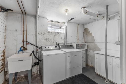 Private laundry with washer and dryer and more space to store items.