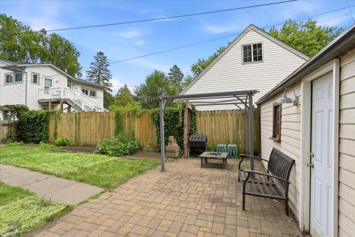 Spacious brick patio in the back yard. The yard is fully fenced for privacy.