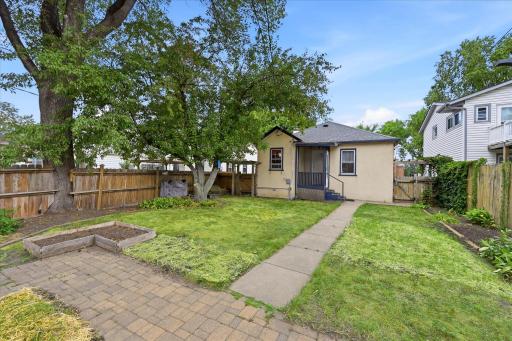 Fully fenced, private back yard has a nice mix of shade and sunlight. A raised garden awaits your planting.