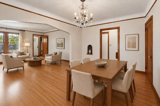 Gleaming original hardwood floors and period details blend with the many updates in the home. Virtually staged living room and dining room.