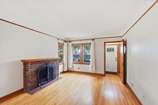 Original brick fireplace hearth. The front entry has a front hall with a closet.