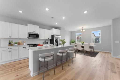The kitchen has timeless finishes that blend an elevated feel with functionality. Similar home shown, see last photo for the interior selections.