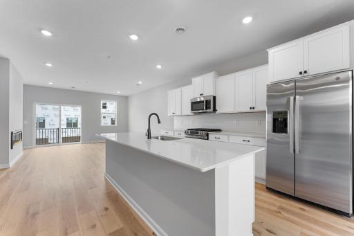 The large multi purpose island adds additional storage, surface space, and seating making entertaining a breeze. Similar home shown, Color and options can vary.